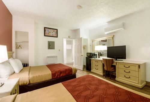 a hotel room with two beds and a desk at Econo Lodge Inn & Suites Lake Harmony - Pocono Mountains Area in White Haven