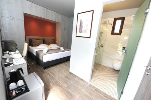 a bathroom with a bed, a toilet and a sink at Castle View Bungalows in Mystras