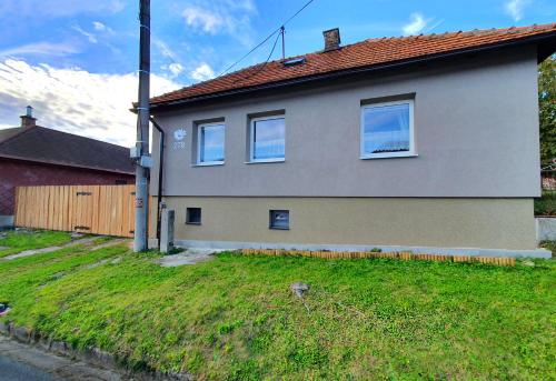a house with three windows on the side of it at Chalupa Margareta in Telgárt