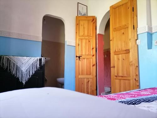 a bedroom with a bed and an open door at Gîte Tamsoulte in Imlil