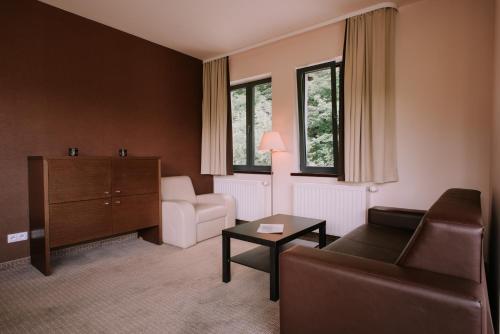 a living room with a couch and a table at Szklane Domy in Zakopane