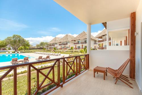 a balcony with a view of a pool and houses at Kiwengwa Beach Resort in Kiwengwa