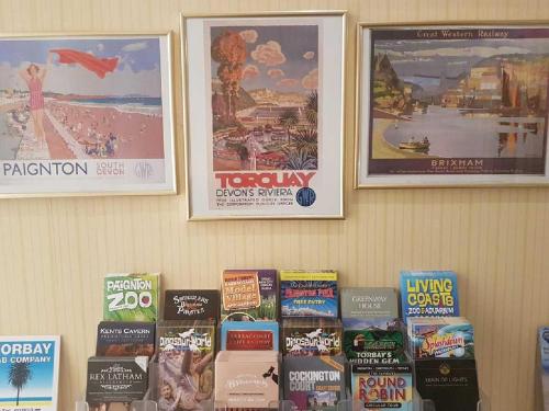 a wall with posters and books on it at The Bahamas in Torquay