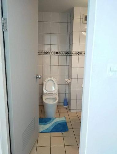 a small bathroom with a toilet in a stall at Grandbeach 1 condo A202 in Rayong