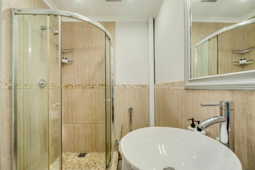 a bathroom with a sink and a shower at 211 De Waterkant Piazza in Cape Town