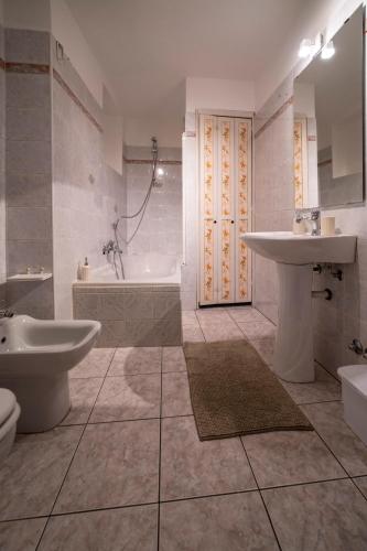 a bathroom with a sink and a tub and a toilet at FISHERMAN in Pisogne