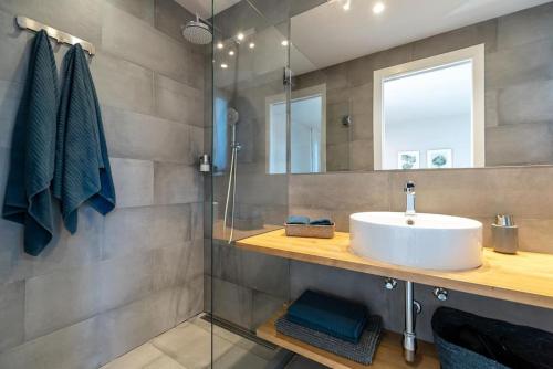 a bathroom with a sink and a glass shower at Gava Ocean View in Gavà
