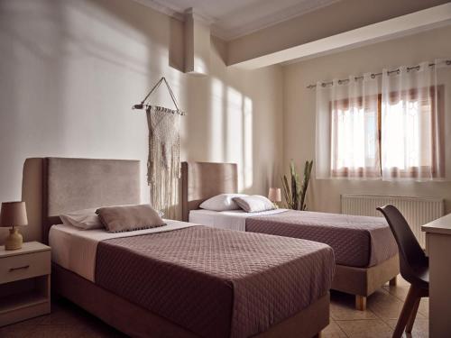 a bedroom with two beds and a window at Lithakia Balcony Villa - Private Pool, Large Groups & Sea View, by ZanteWize in Lithakia