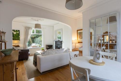 a living room with a couch and a table at Beersbridge Cottage near Titanic Centre & Airport in Belfast