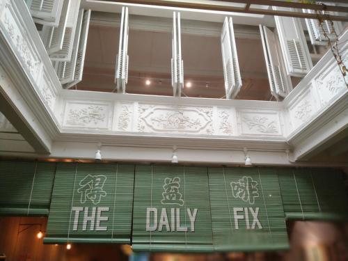 a sign that reads the daily tv hanging from a ceiling at Alimama Guesthouse Melaka with Balcony in Melaka