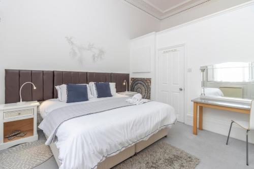a bedroom with a large bed and a sink at Seaview Regency Apartment in Torquay