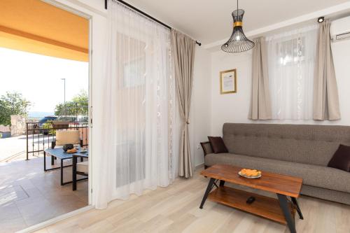 a living room with a couch and a table at La Vista apartments in Salatić