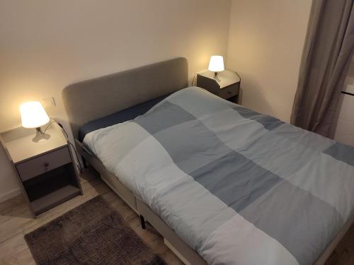 a bedroom with a bed and two night stands with lamps at *** les loges de la friche DMC *** in Mulhouse