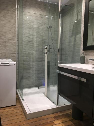 a bathroom with a glass shower and a sink at Le Clos des Marmottes in Cauterets