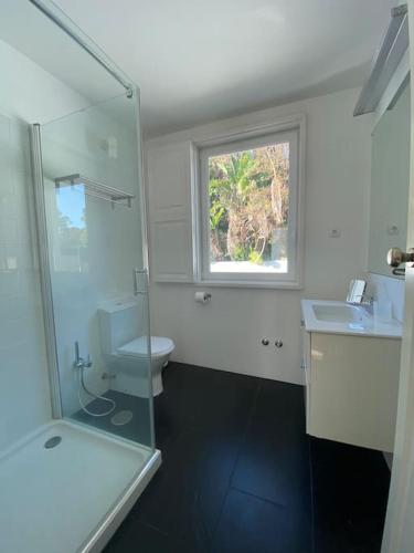 a bathroom with a toilet and a sink and a window at Belém Fantastic Triplex House in Lisbon