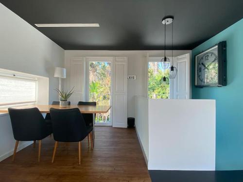 a dining room with a table and black chairs at Belém Fantastic Triplex House in Lisbon