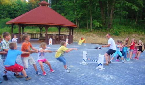 a group of children playing with a rope at Dwór Maria Antonina in Strzyżów