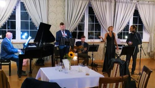 a group of people playing music in a room at Dwór Maria Antonina in Strzyżów