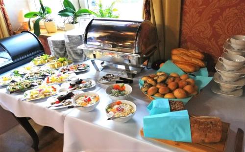 a table with many plates of food on it at Dwór Maria Antonina in Strzyżów