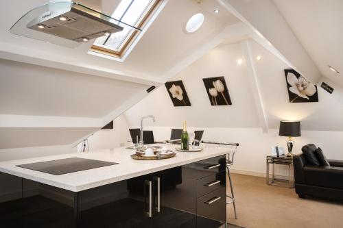 an attic kitchen with a white counter and a skylight at Lincoln House Private Hotel in Cardiff
