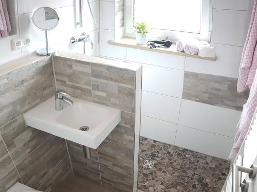 a bathroom with a sink and a shower at Landhaus Hochgern in Unterwössen