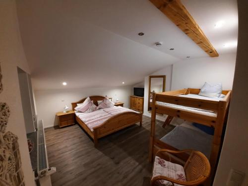 a bedroom with two beds and a bunk bed at Landhaus Hochgern in Unterwössen