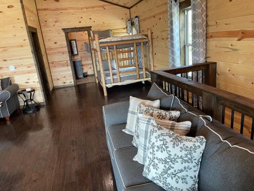 a living room with a couch in a cabin at Chalet Village- Amazing Mountain Views - Piney Butt Place in Gatlinburg