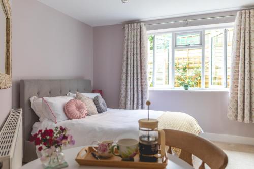 um quarto com uma cama e uma mesa com uma bandeja em The Costrel em Tenbury