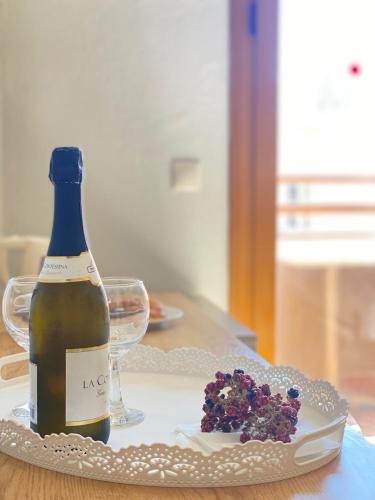 a bottle of wine sitting on a table next to a glass at Louvre Hotel in Gouvia