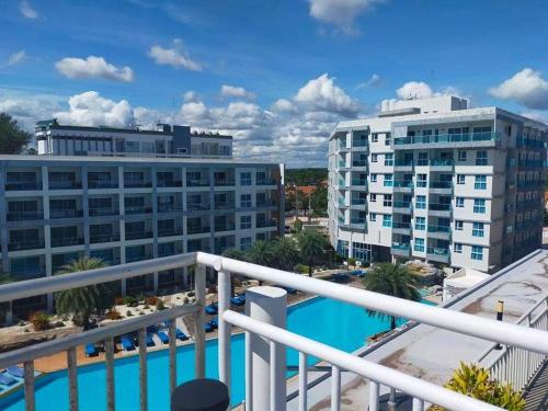 a view of the pool from the balcony of a hotel at Grandbeach 1 condo A202 in Rayong