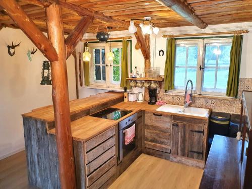 a kitchen with wooden cabinets and a counter top at Ranczo Annabella in Przybiernów