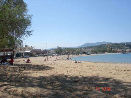 a group of people on a beach near the water at Breathtaking sea and Mountain views with Private pool, Peace full relaxing Villa with WiFi near Shops and Restaurants in Epáno Kefalás