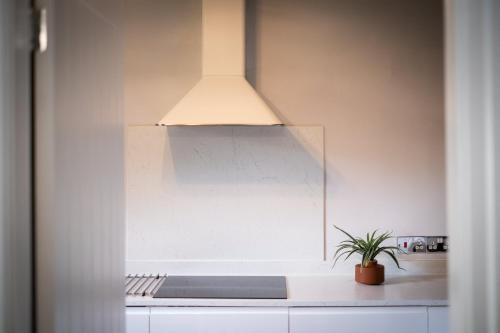 a kitchen with a light hanging over a counter at Bellman apartment - Pet friendly with parking - FREE off-site Health Club access with Pool, Sauna, Steam Room & Gym Short 10 Minute Drive Away in Winster