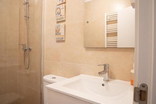 a bathroom with a sink and a shower at Spacious and Sunny Apartment - 10 min from the sea in Estoril