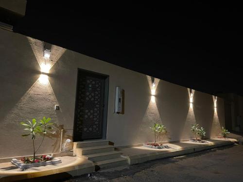 a building with stairs and a door with lights at شاليه العبير in Buraydah