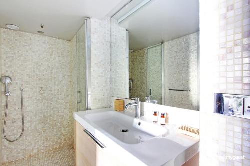 a bathroom with a sink and a shower at Superbe Loft 2BR - Buttes Chaumont in Paris