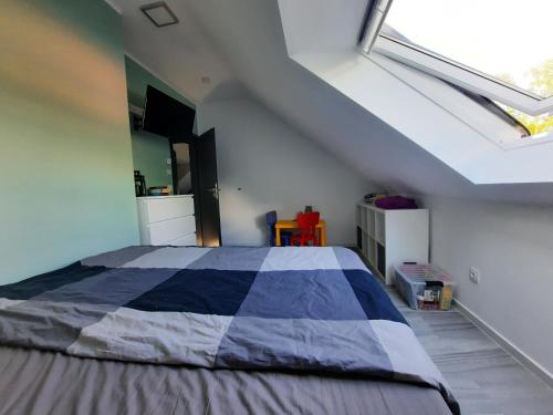 a bedroom with a large bed in a attic at Zum Waldblick in Funfseen