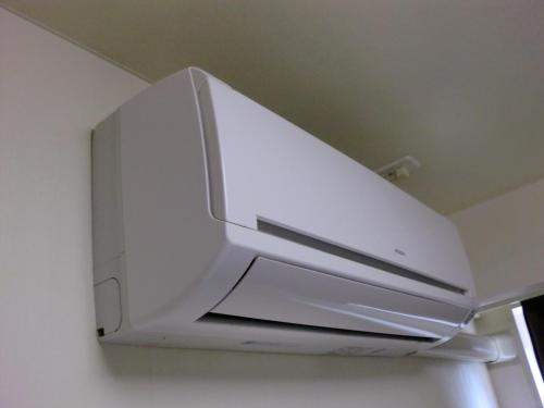 a white projector hanging from the ceiling of a room at Green Rich Hotel Suizenji in Kumamoto
