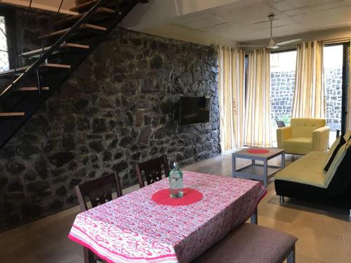 a dining room with a table with a pink table cloth at Enliven Homestay Alibag, Alibaug in Nagaon