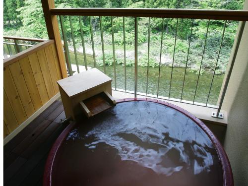 a room with a table in the middle of a room with a world in it at 游泉志だて in Hanamaki