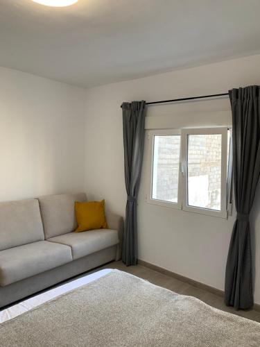 a living room with a couch and a window at Villa Rosaura in Las Palmas de Gran Canaria