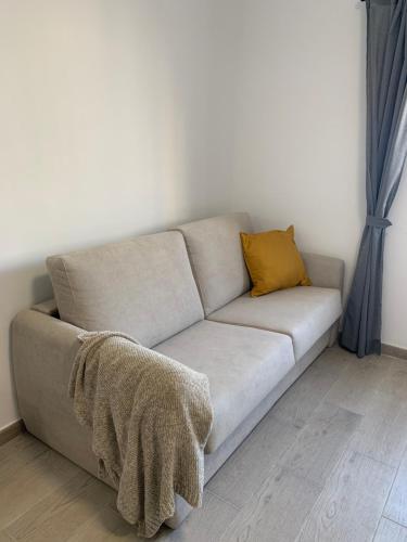 a couch with two pillows on it in a room at Villa Rosaura in Las Palmas de Gran Canaria