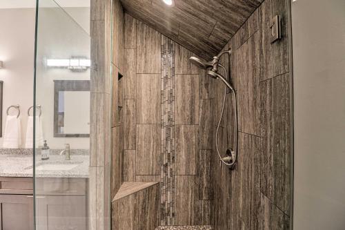 a shower in a bathroom with a wooden door at Modern Kalispell Retreat 37 Mi to Glacier NP in Kalispell