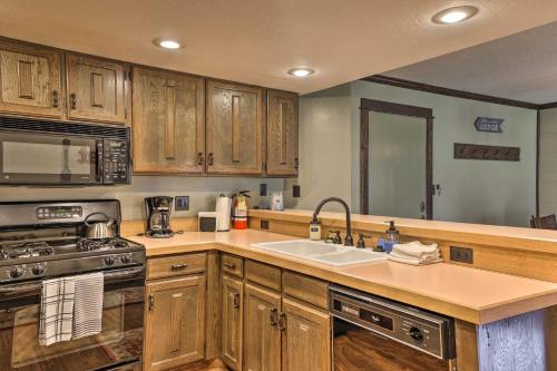 a kitchen with a sink and a stove top oven at Brian Head Condo with Patio and Community Amenities! in Brian Head