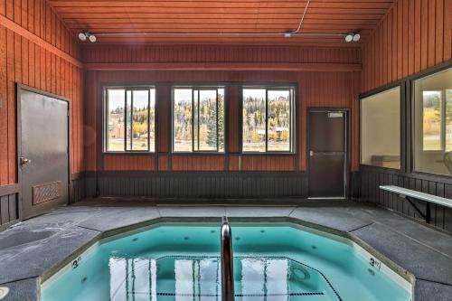 a hot tub in a room with windows at Brian Head Condo with Patio and Community Amenities! in Brian Head