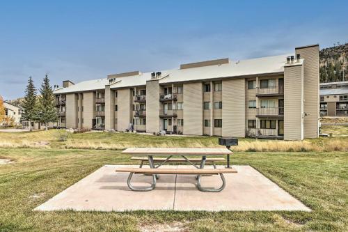 a picnic table in front of a building at Brian Head Condo with Patio and Community Amenities! in Brian Head