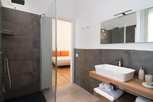 a bathroom with a sink and a glass shower at L'isola che c'è in Cagliari