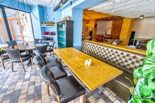 a dining room with a wooden table and chairs at GVC New Gudauri Alpic Mountain view in Gudauri