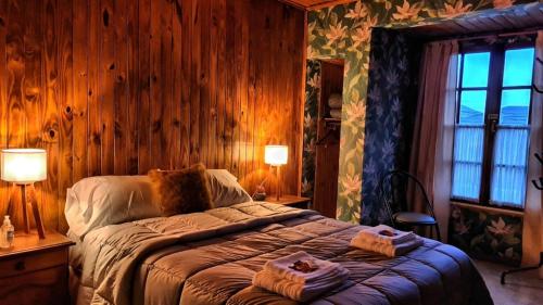 a bedroom with a bed with two towels on it at Hotel Lago del Desierto in El Chalten