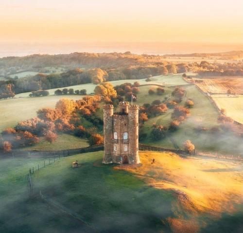 a painting of a castle in the middle of a field at Little Campden House in Chipping Campden